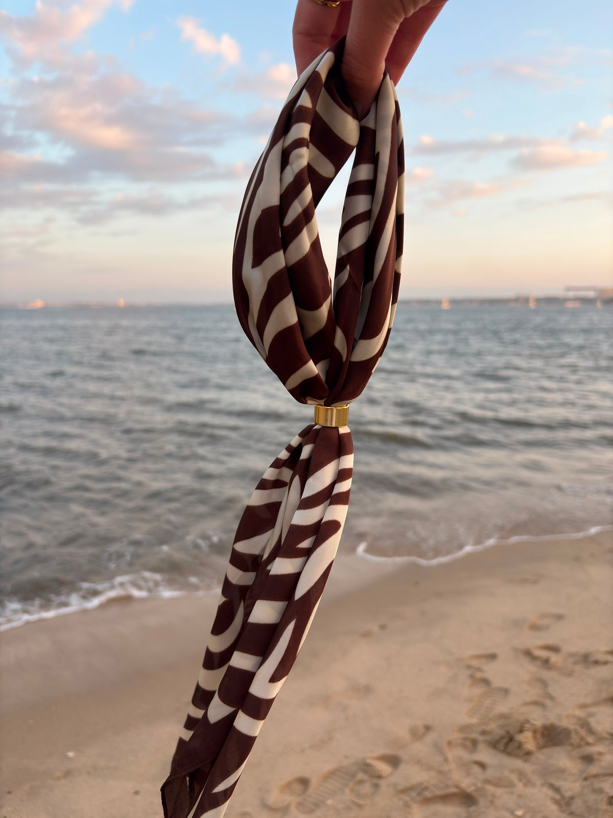 Marron Scarf held at the beach
